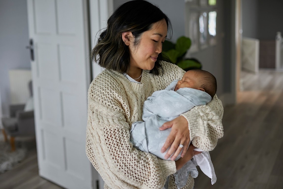 Mum holding wrapped Newborn baby